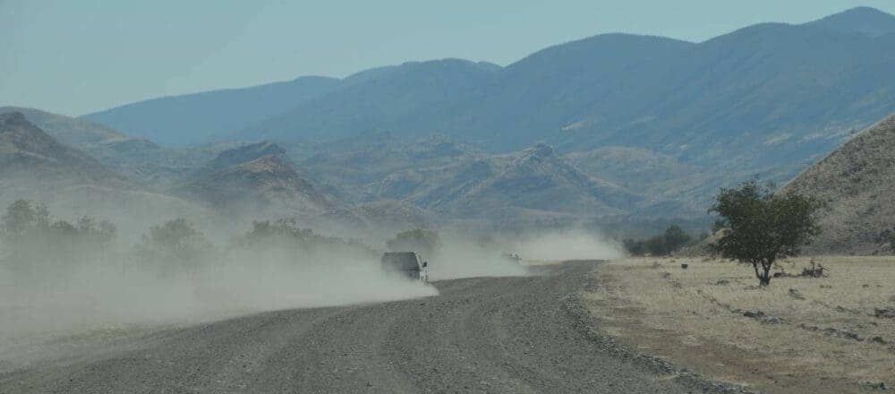 header image dusty clouds on a gravel road - Dusty Trails Safaris Namibia & Dusty Car Hire Namibia