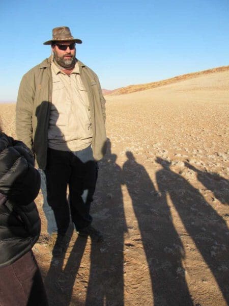 herman oosthuizen talking on front of a group - Dusty Trails Safaris Namibia & Dusty Car Hire Namibia